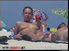 A lovely chick in a nude beach spy cam video video on WebcamWhoring.com